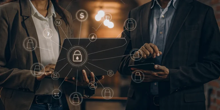 Cybersecurity professionals analyzing a risk-based vulnerability management platform on a laptop.